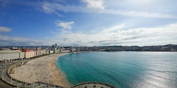 a beach with buildings and water