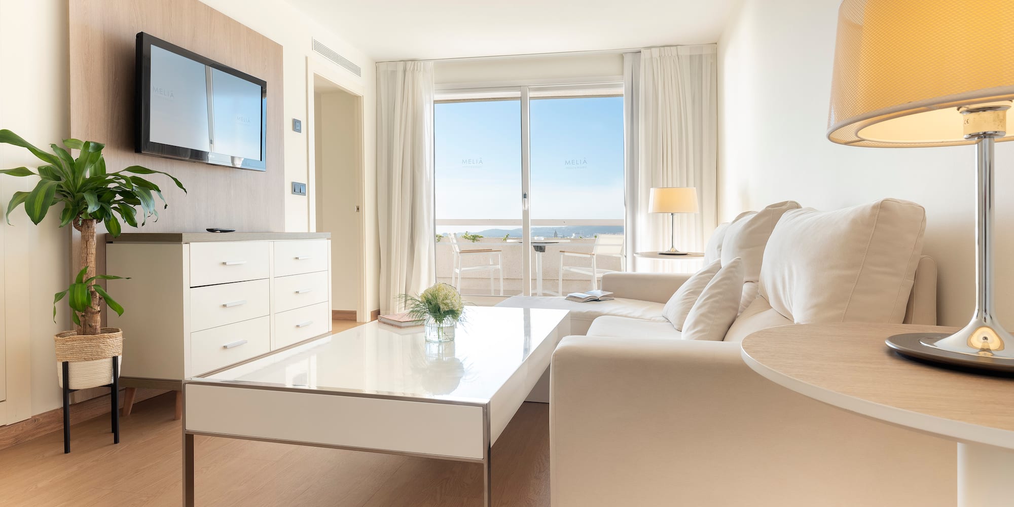 a living room with a white couch and a white coffee table