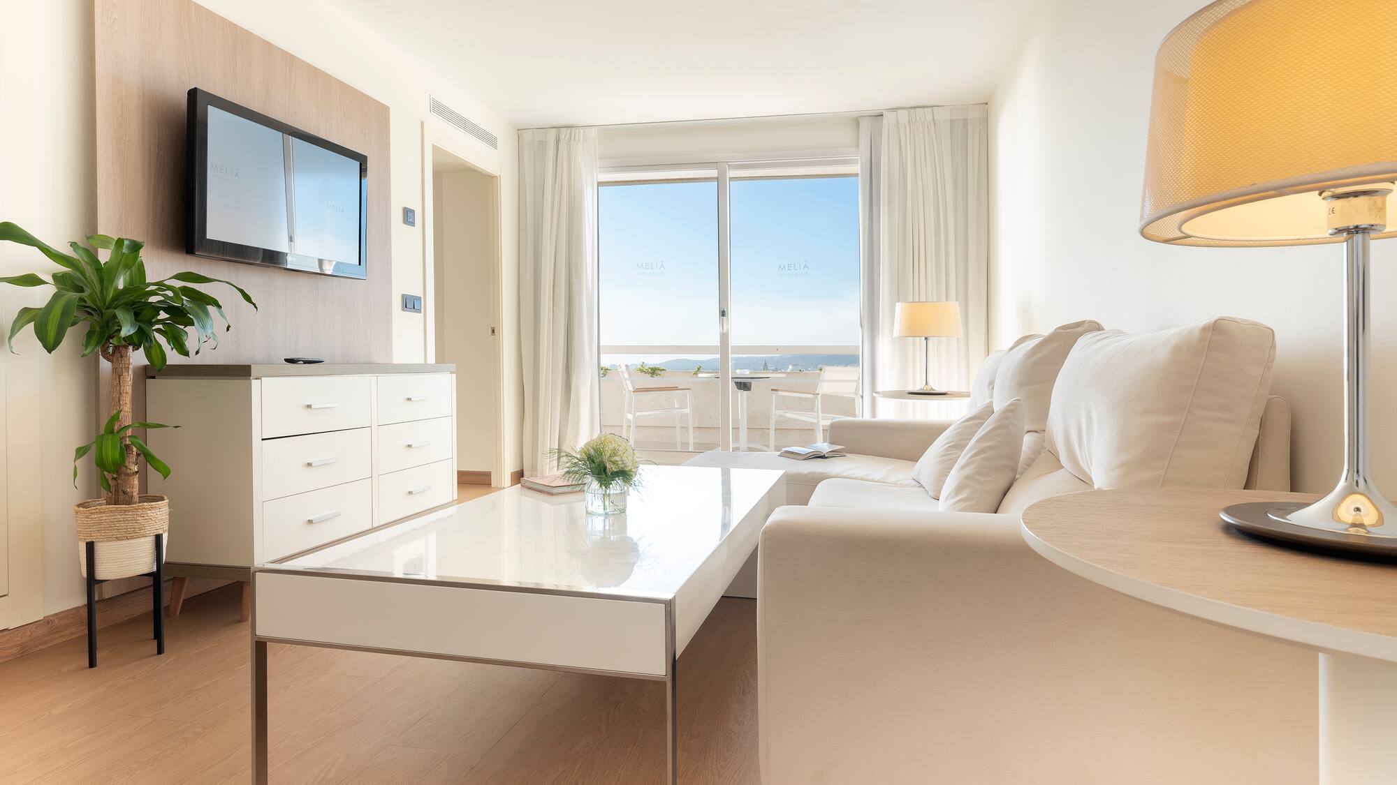 a living room with a white couch and a white coffee table