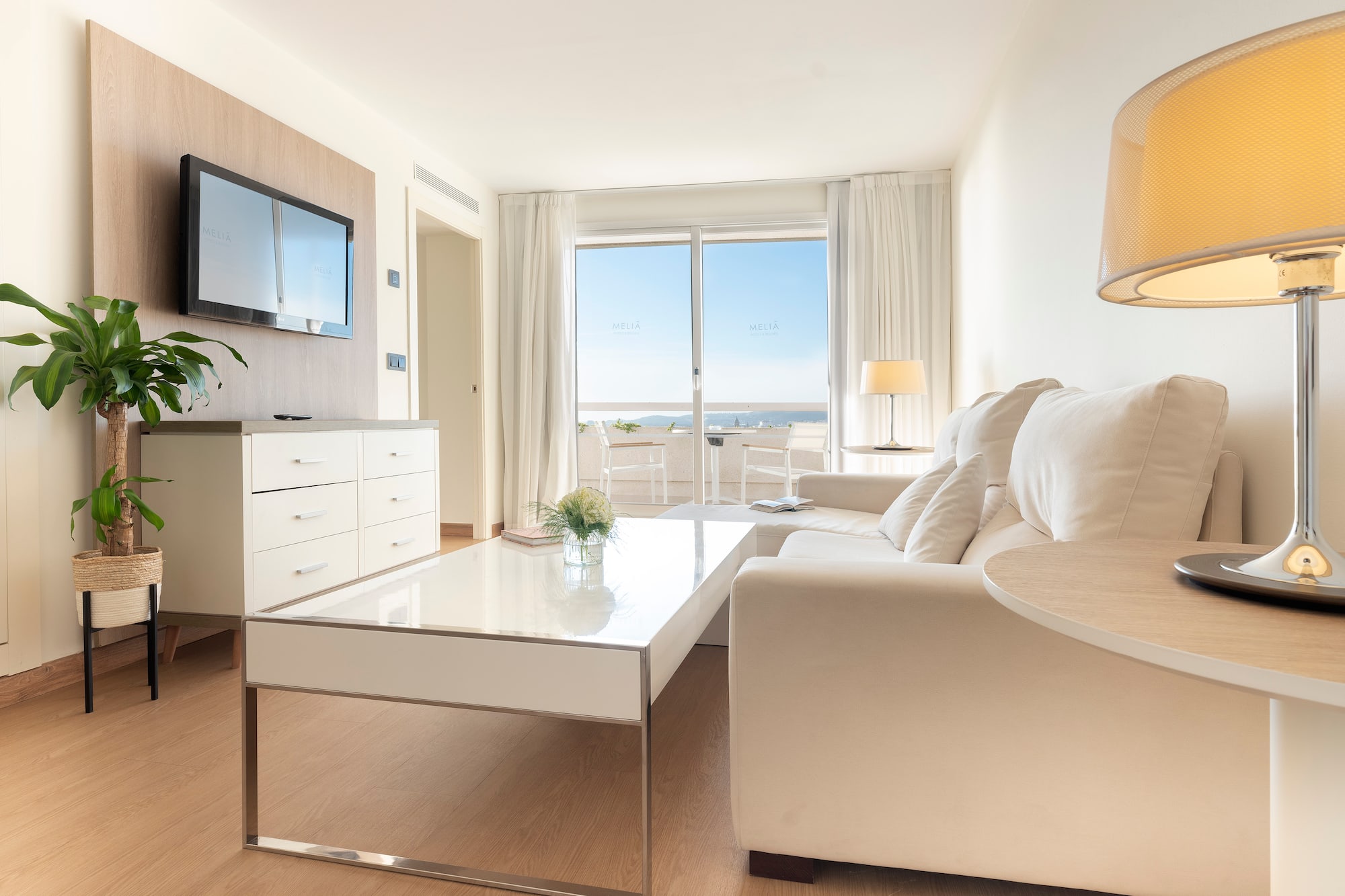 a living room with a white couch and a white coffee table