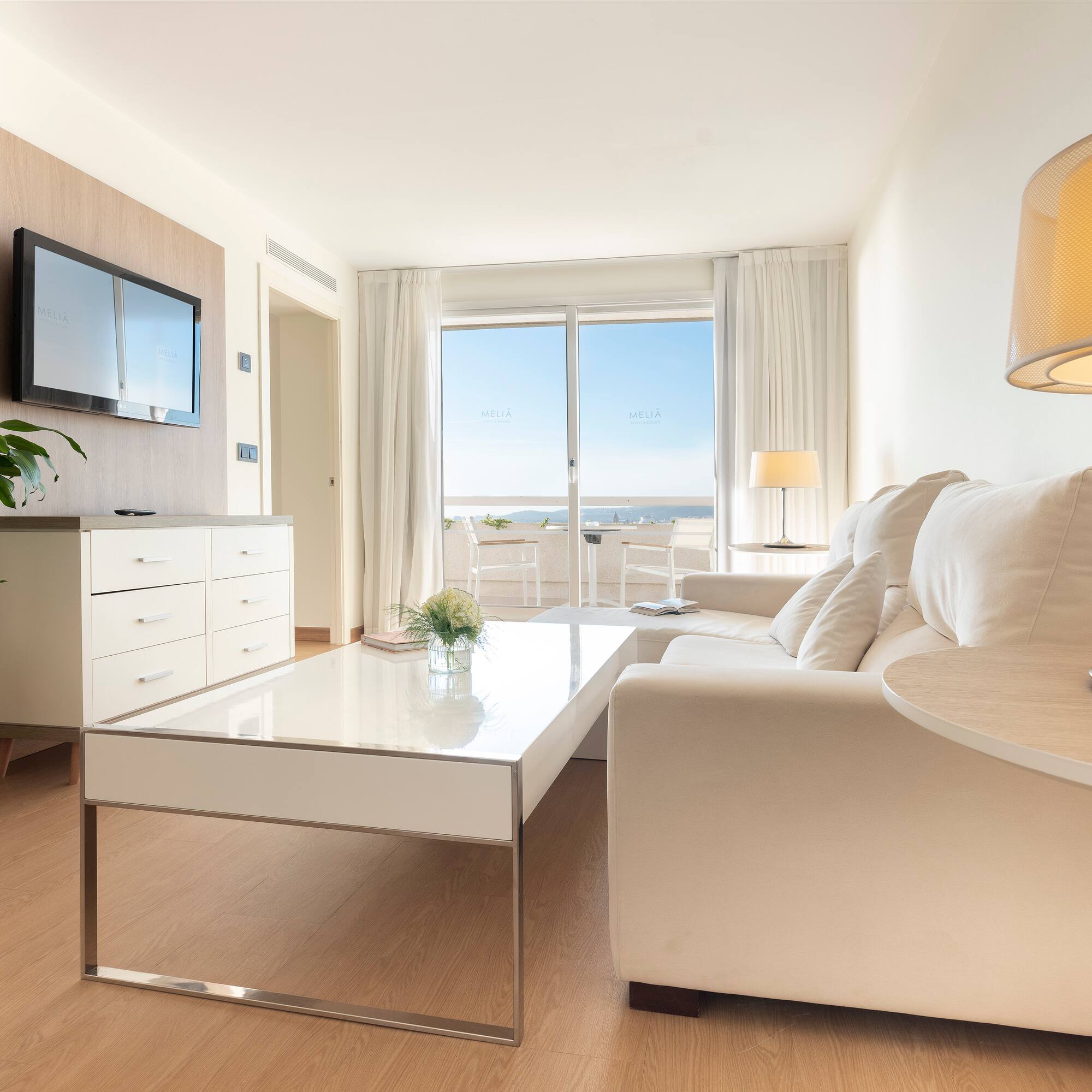 a living room with a white couch and a white coffee table