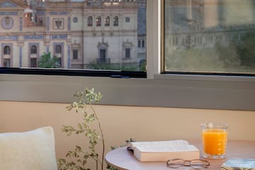 a table with a book and a glass of juice on it