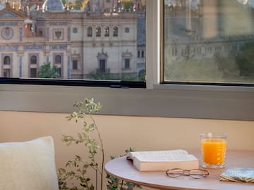 a table with a book and a glass of juice on it