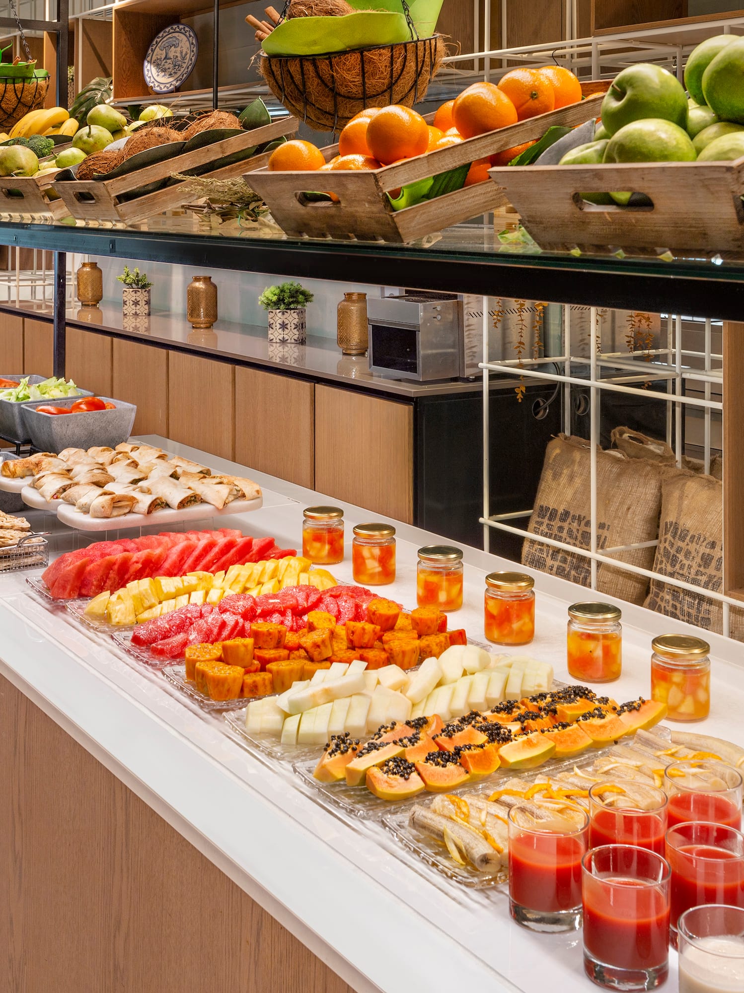 a counter with fruit and drinks on it
