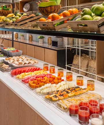 a counter with fruit and drinks on it
