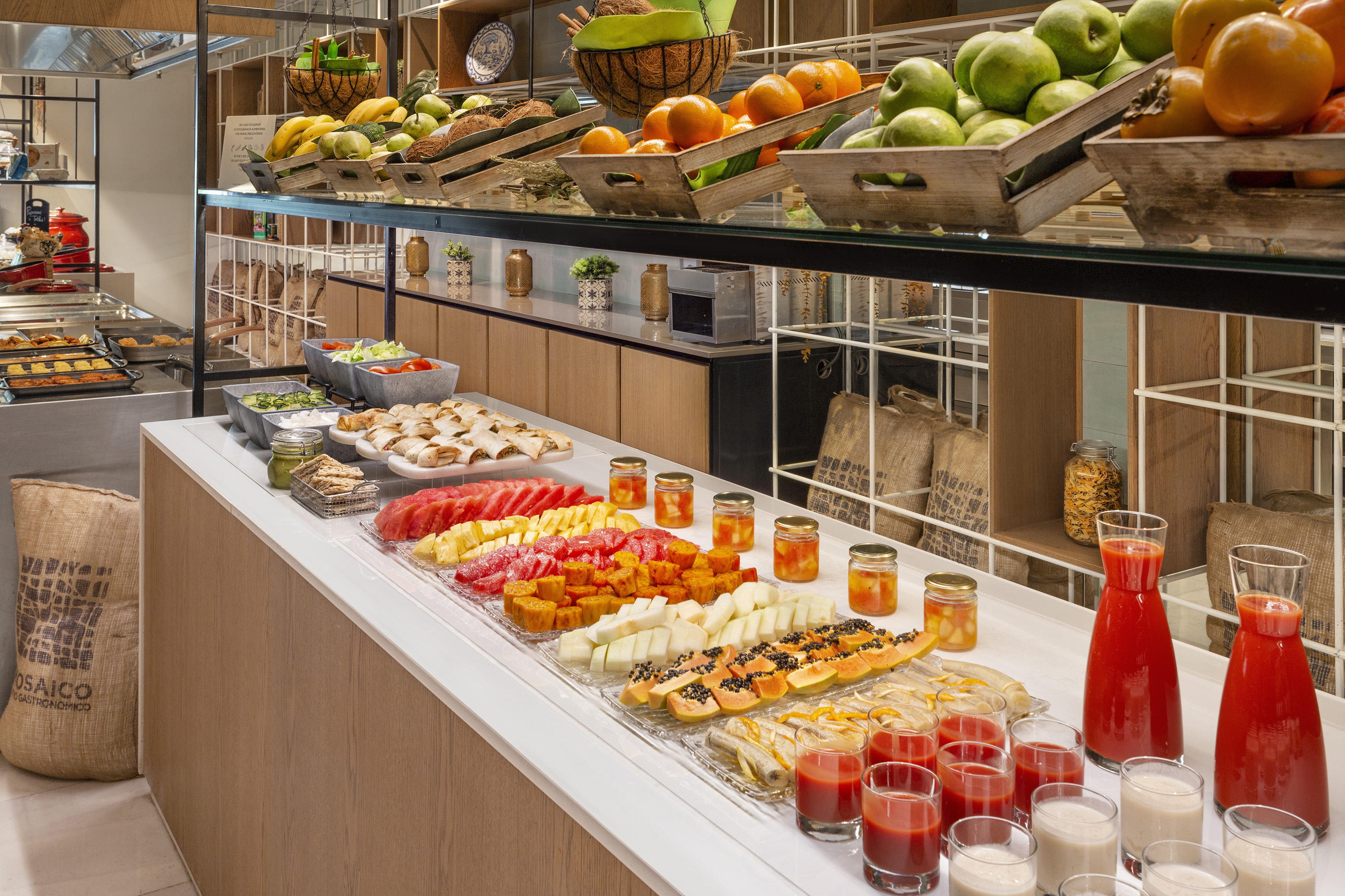 a counter with fruit and drinks on it