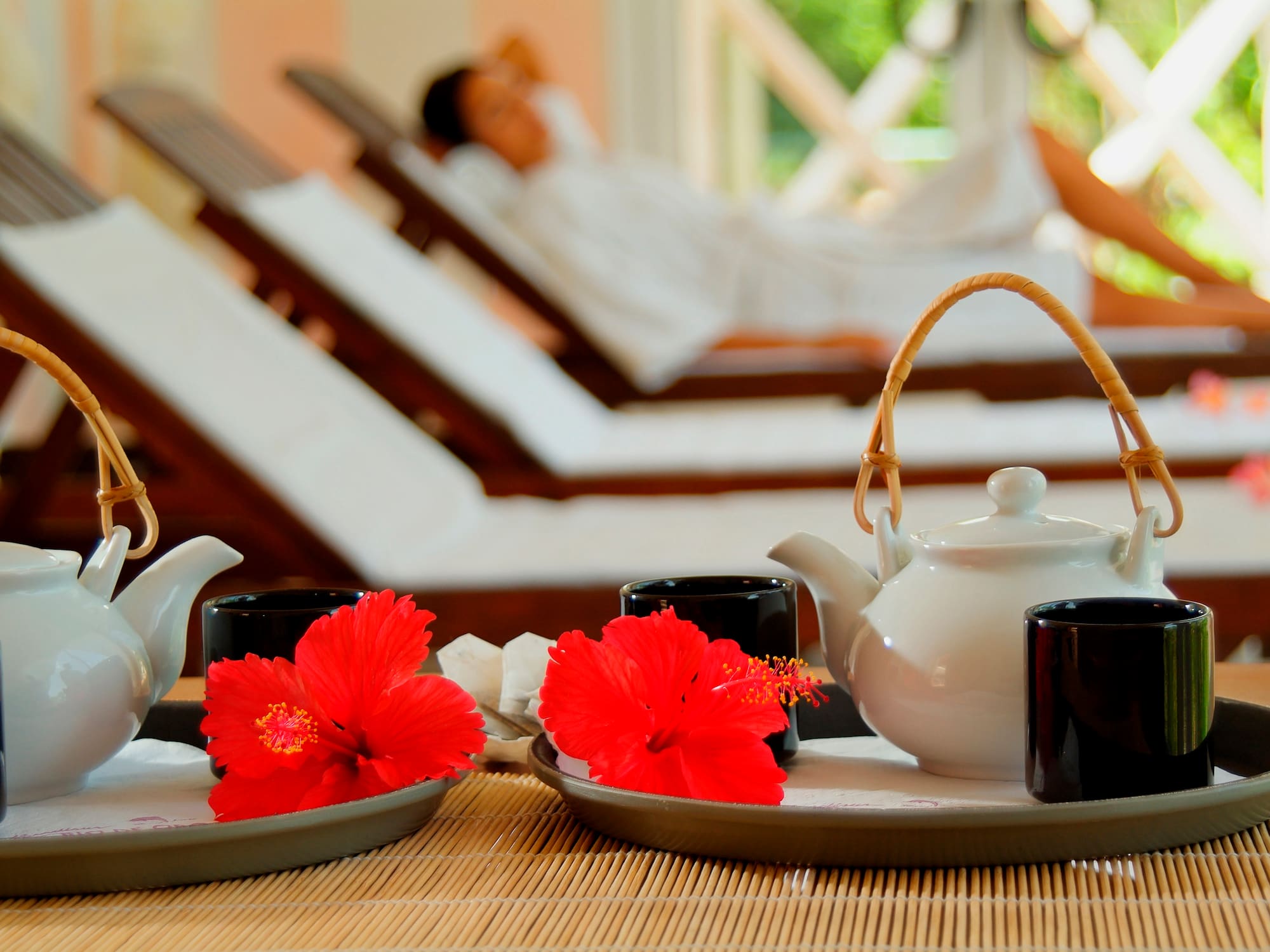 a tea set on a tray with red flowers