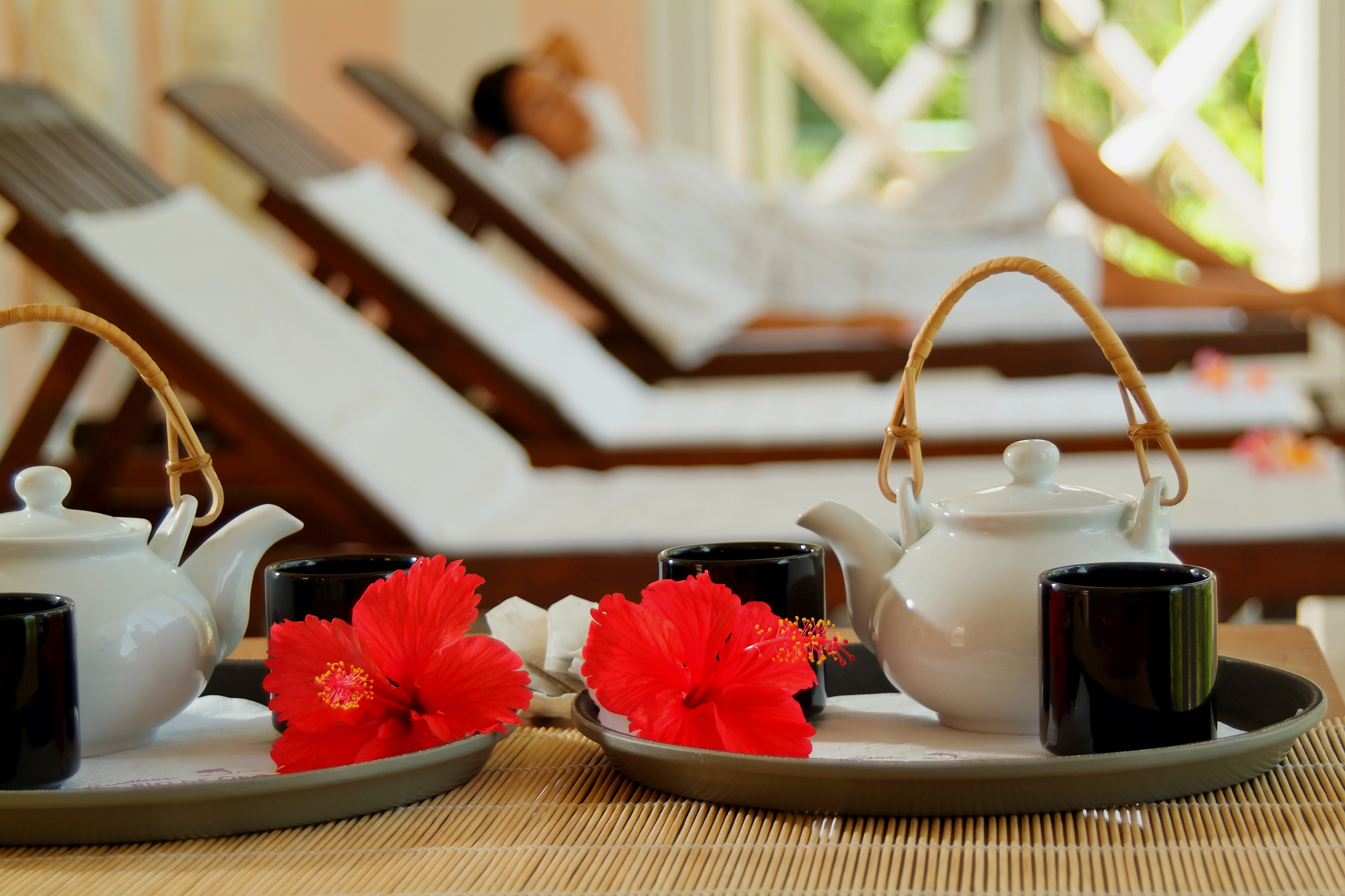 a tea set on a tray with red flowers