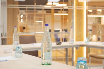 a table with water bottles and papers on it