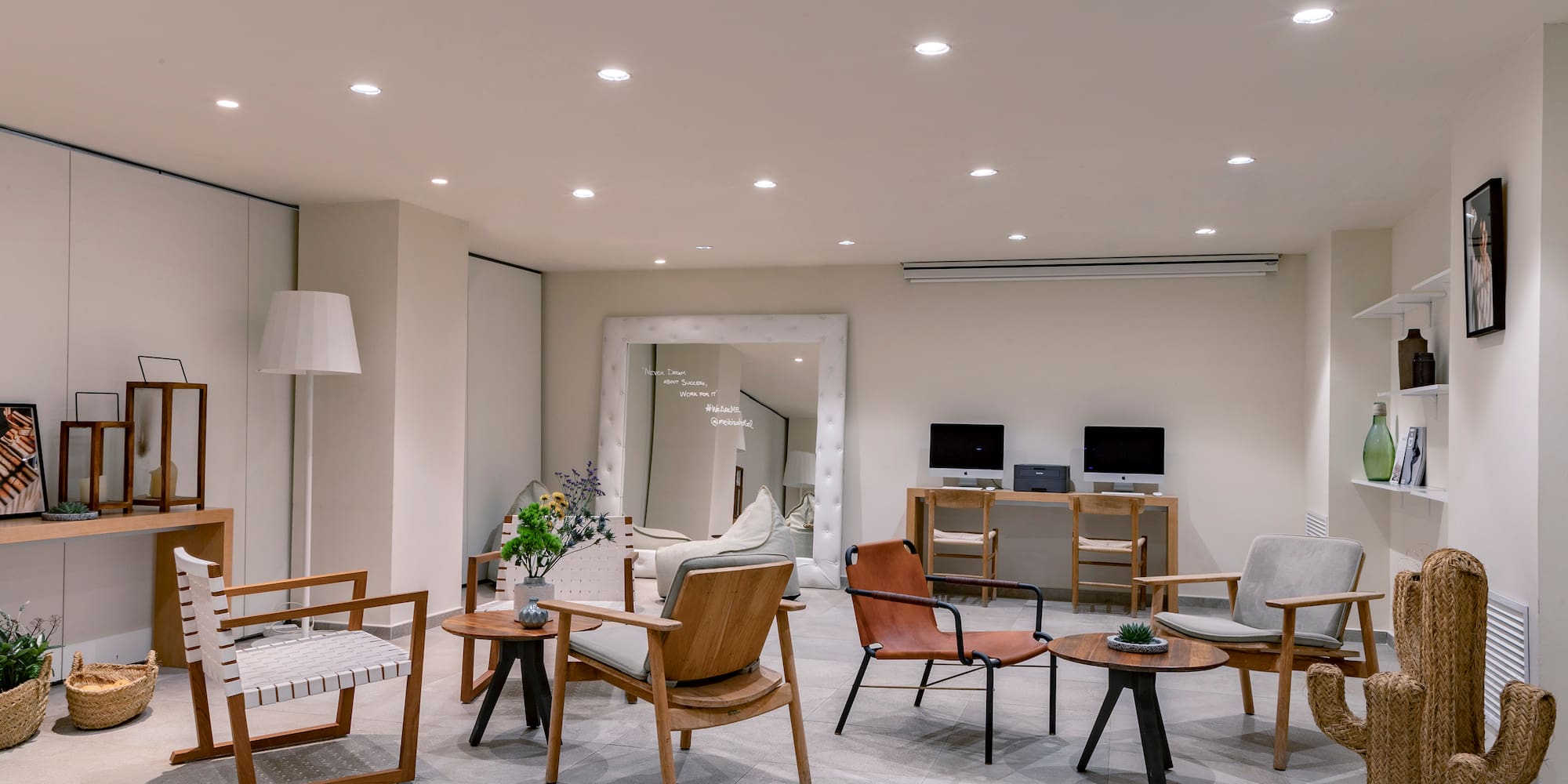 a room with a large mirror and chairs