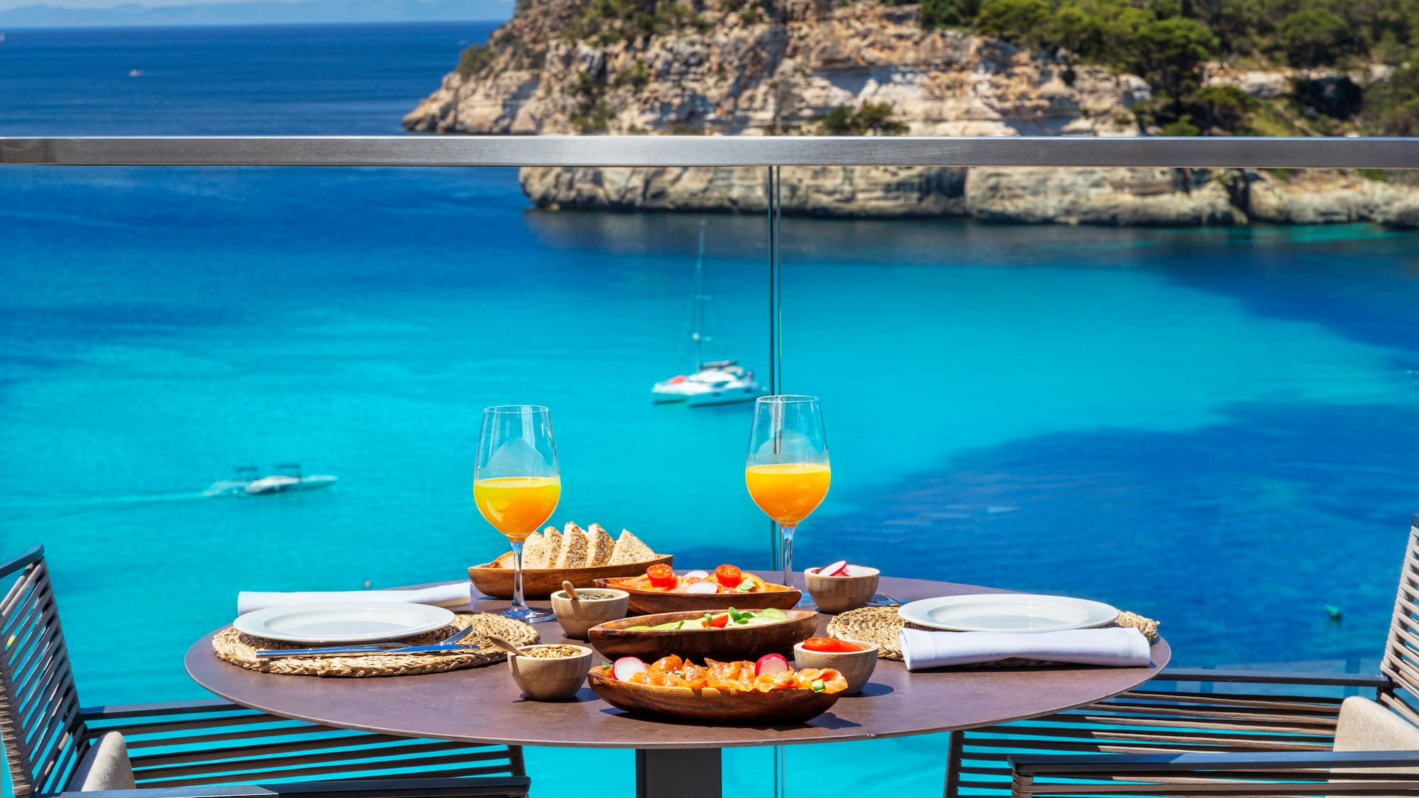 a table with food on it and glasses of orange juice on it
