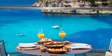 a table with food on it and glasses of orange juice on it