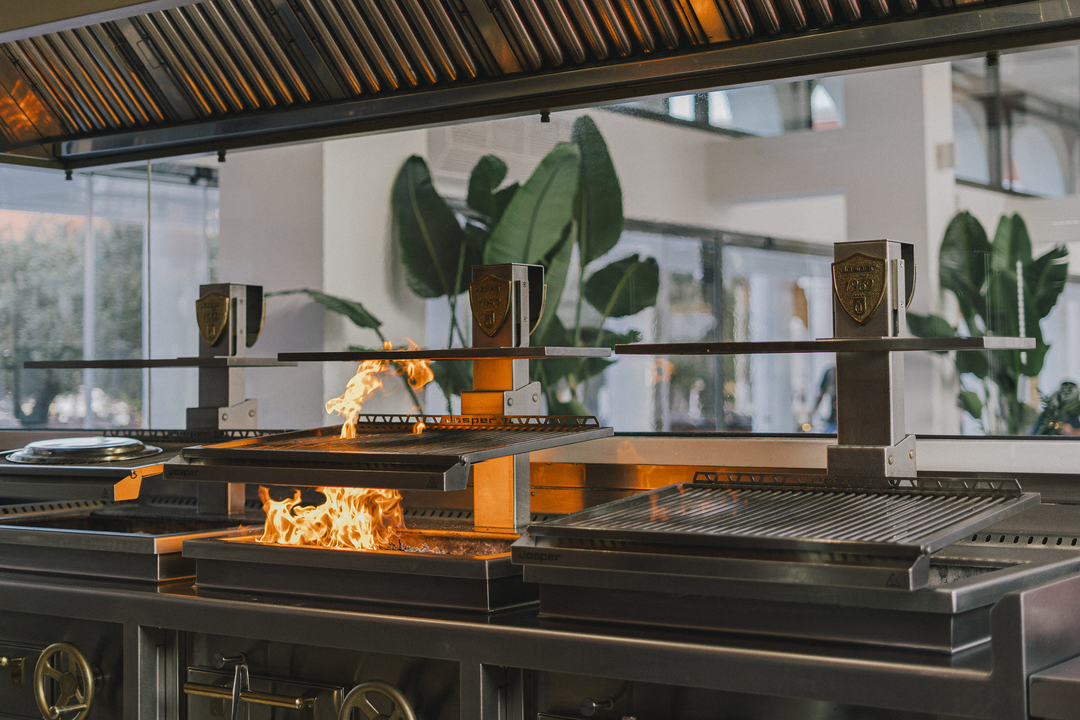 Active flames on Josper commercial grill in a professional kitchen.