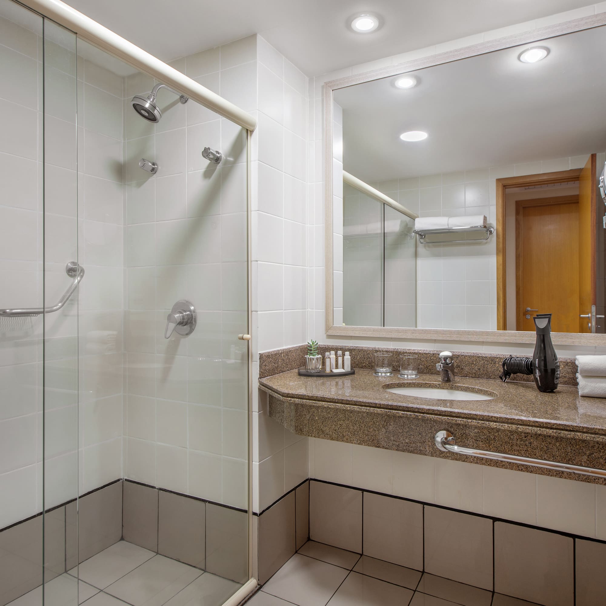 a bathroom with a shower and sink