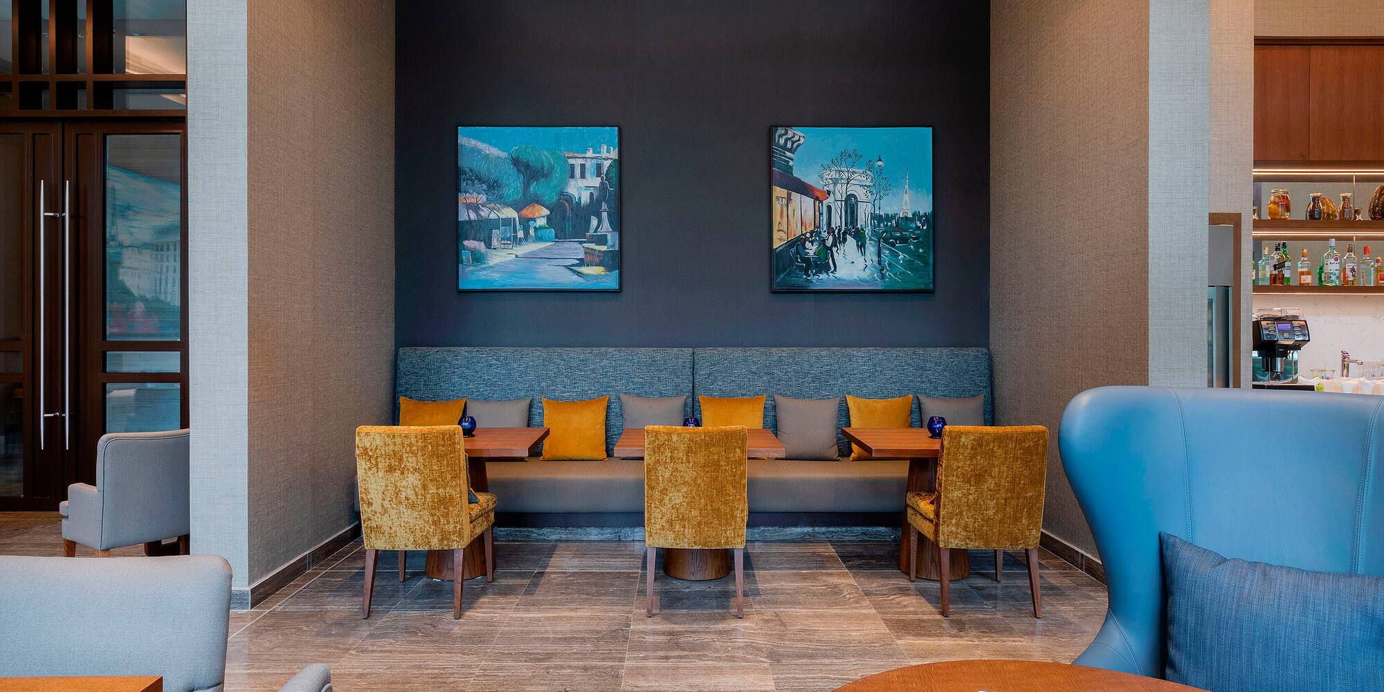 a room with a couch and chairs