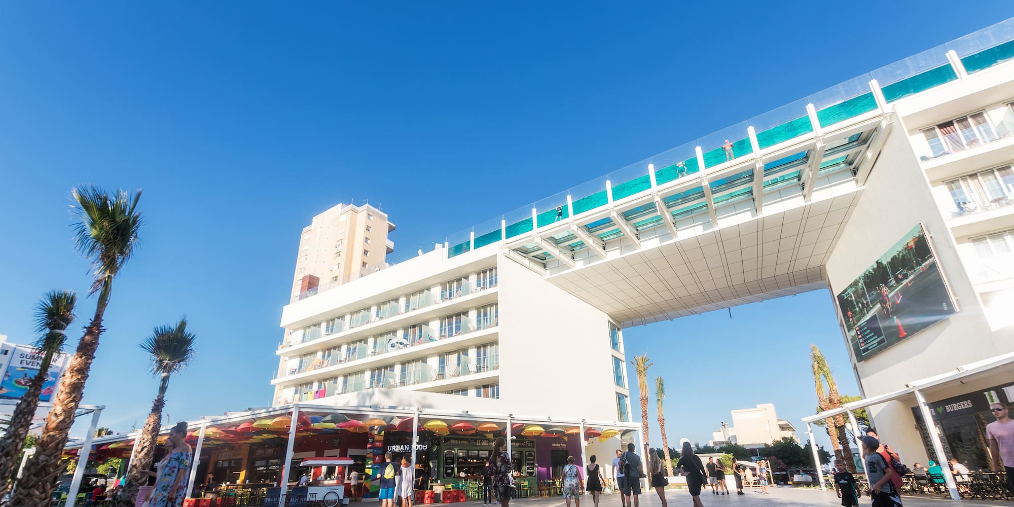 a group of people walking under a bridge