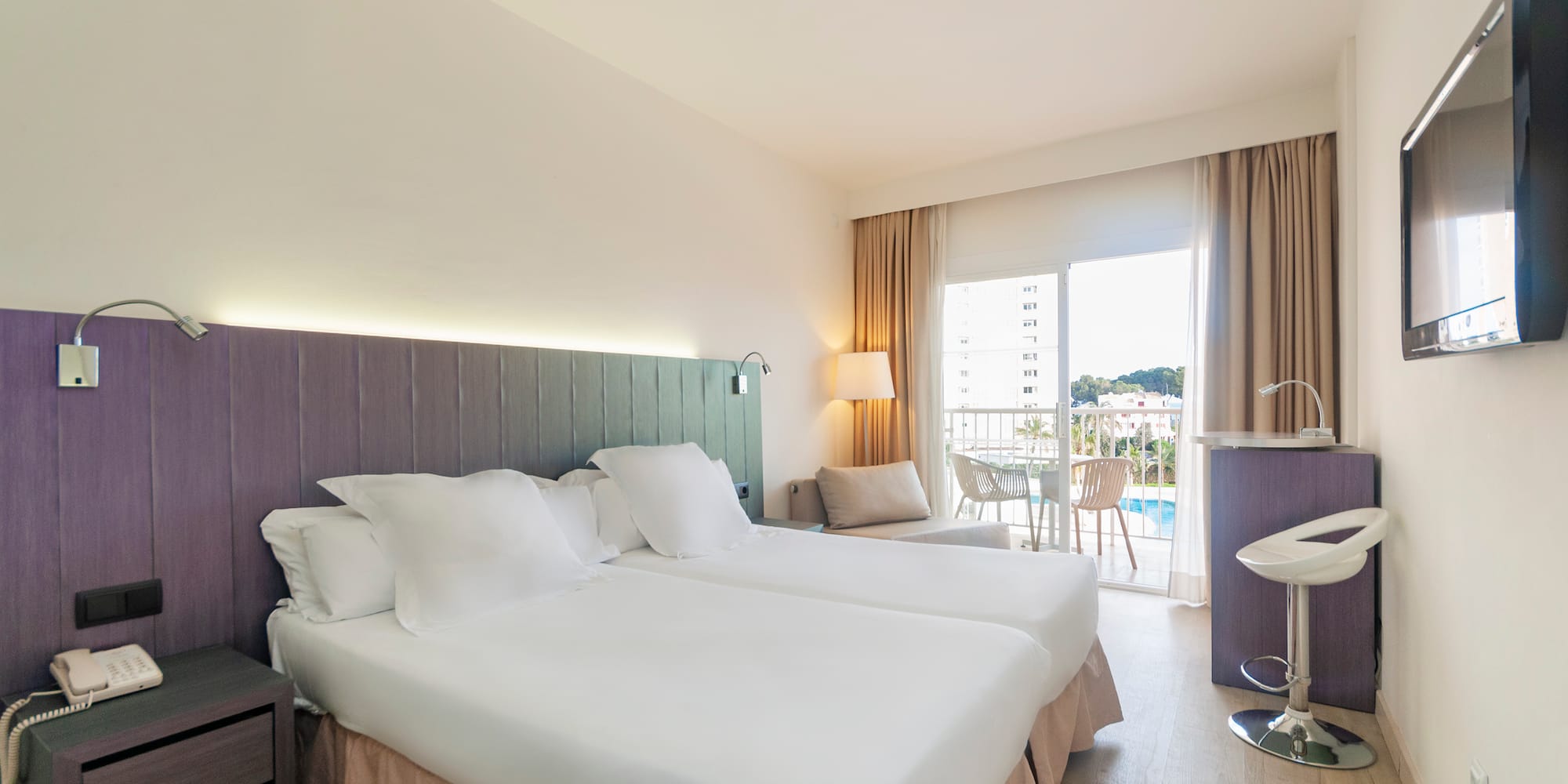 a hotel room with two beds and a sink