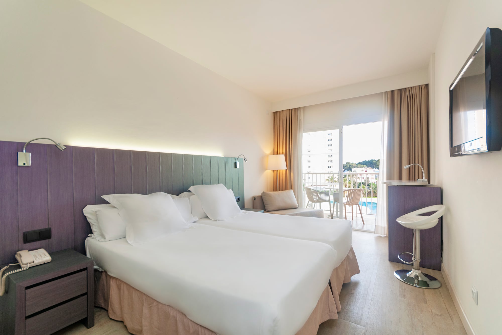 a hotel room with two beds and a sink