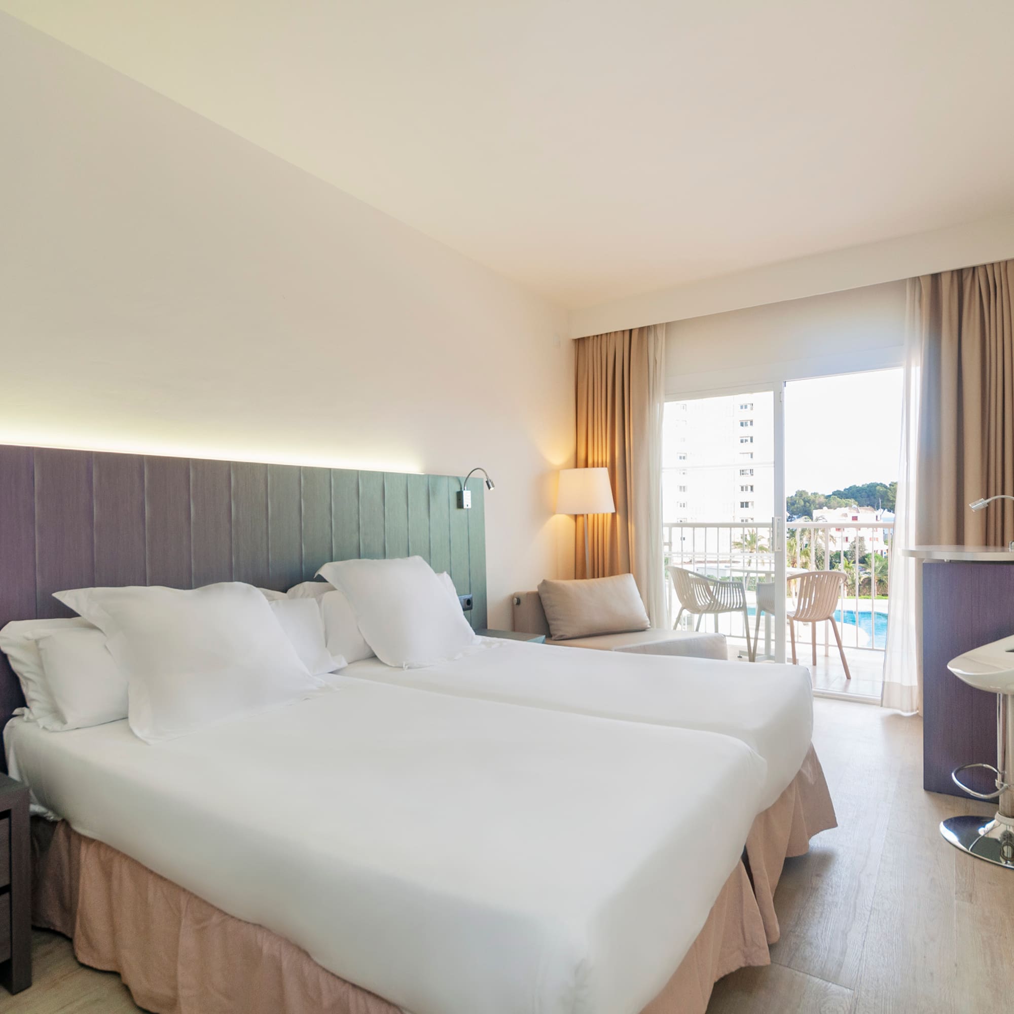 a hotel room with two beds and a sink