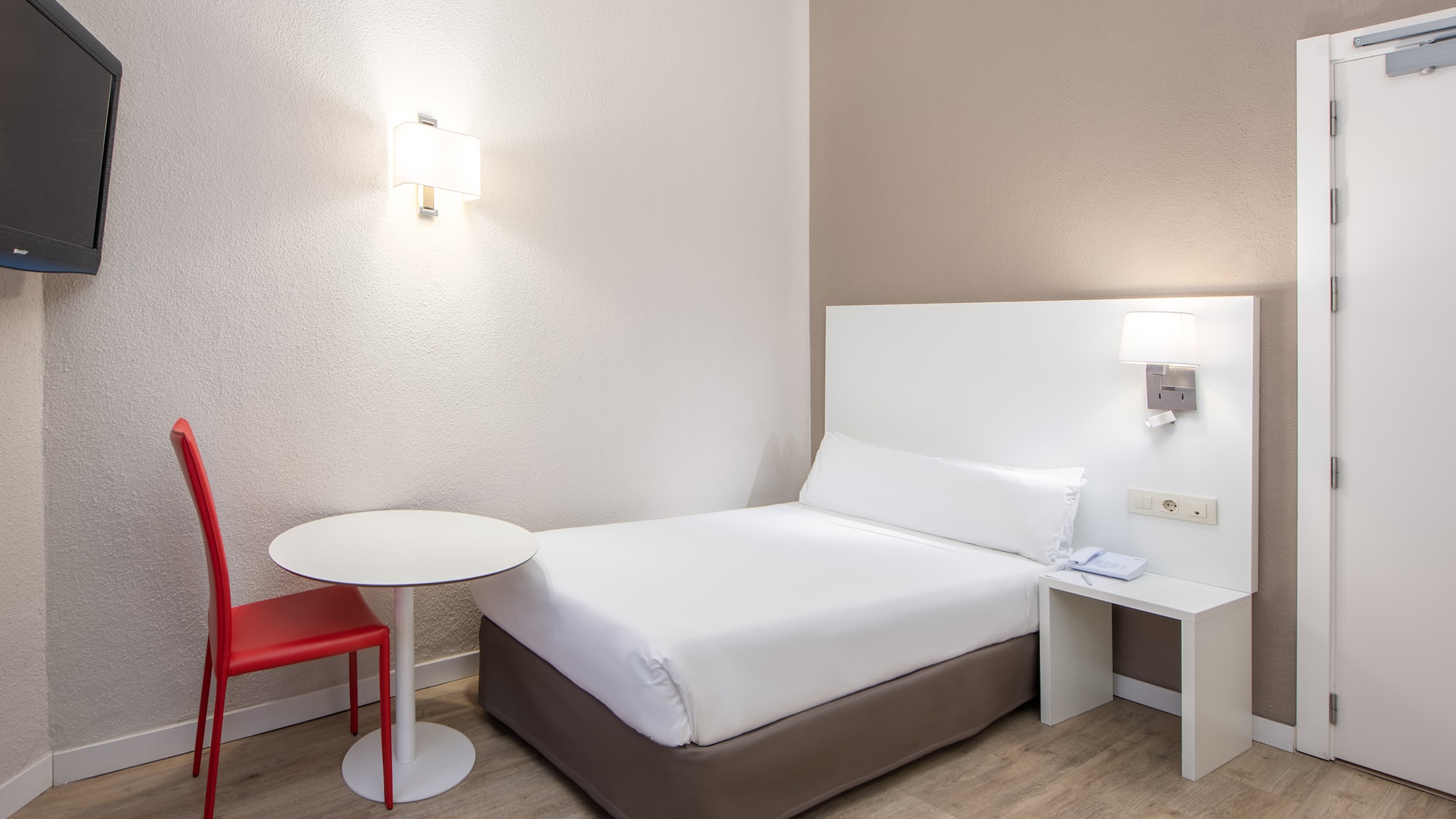 a bed with a table and lamp