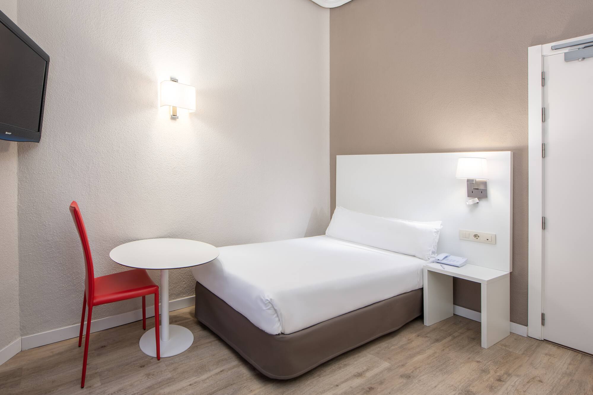 a bed with a table and lamp