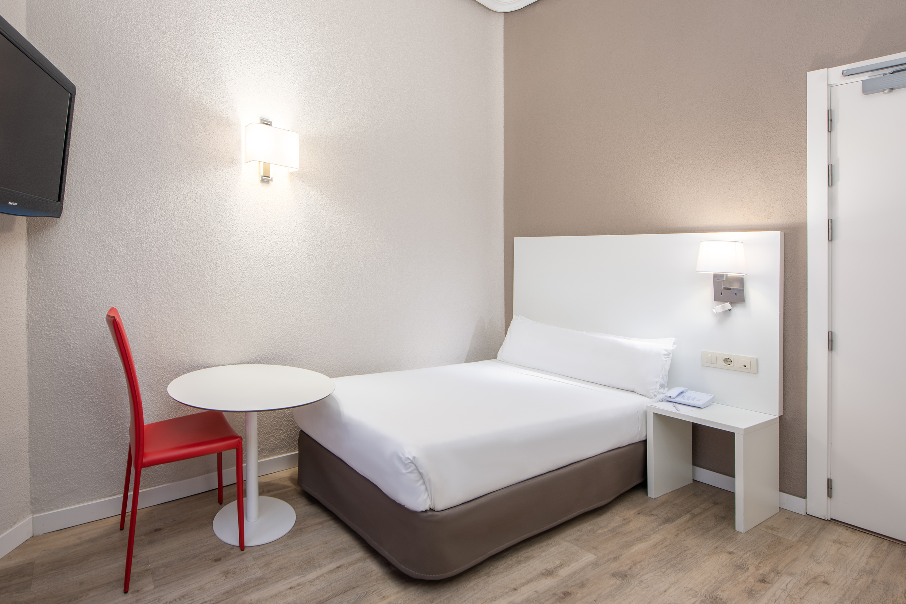 a bed with a table and lamp