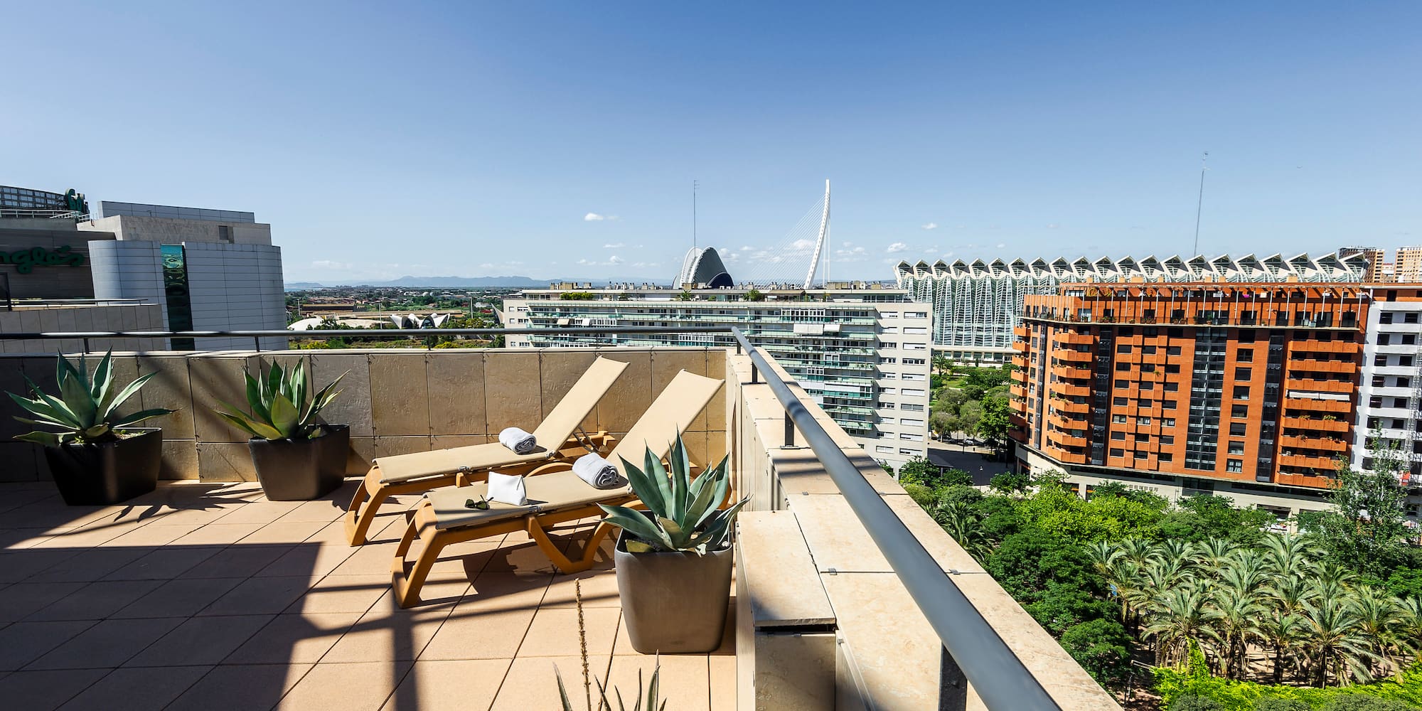 a deck with chairs and plants on it