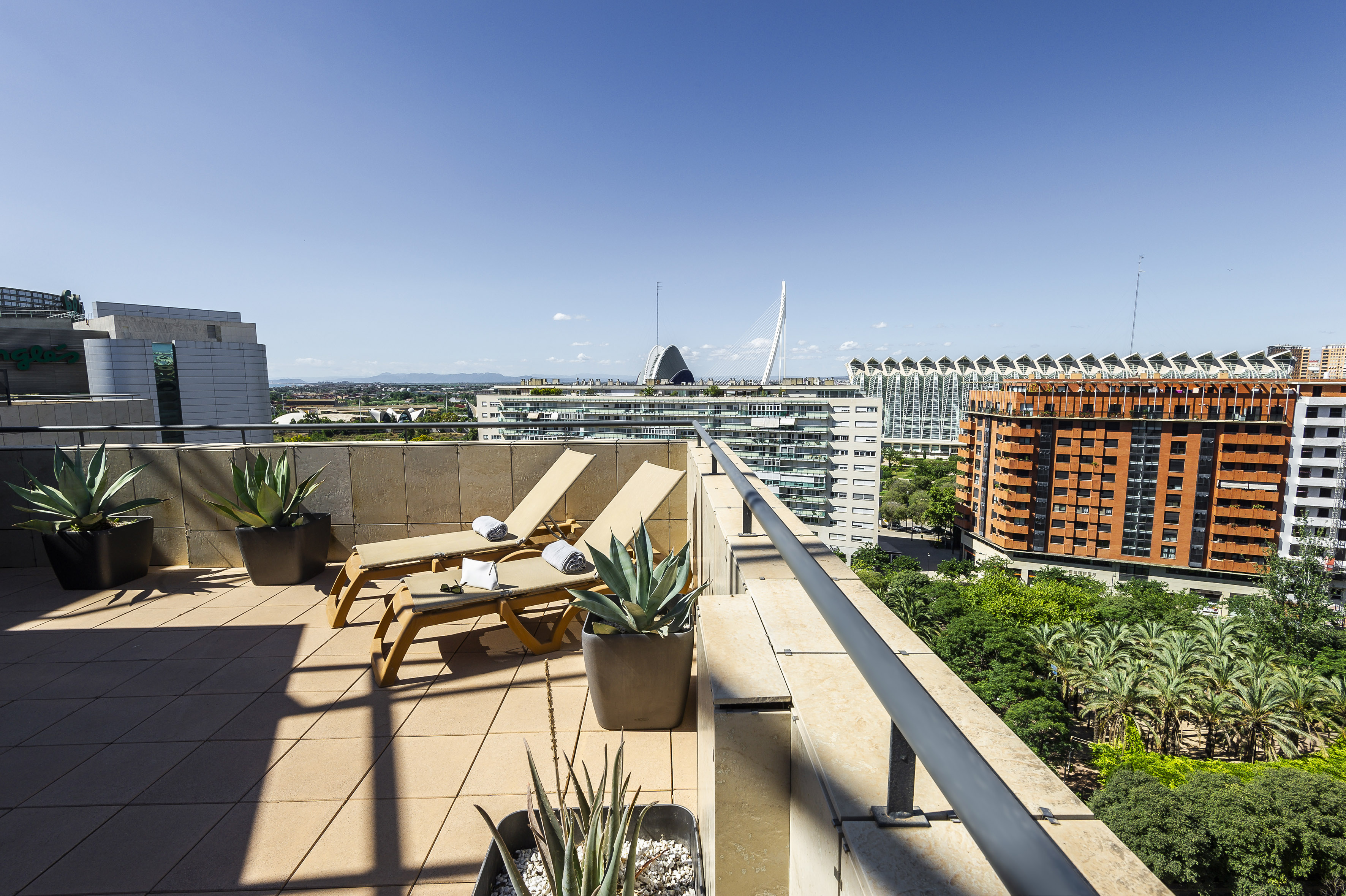 Valencia rooftop terrace, sun loungers, agave, City of Arts and Sciences.