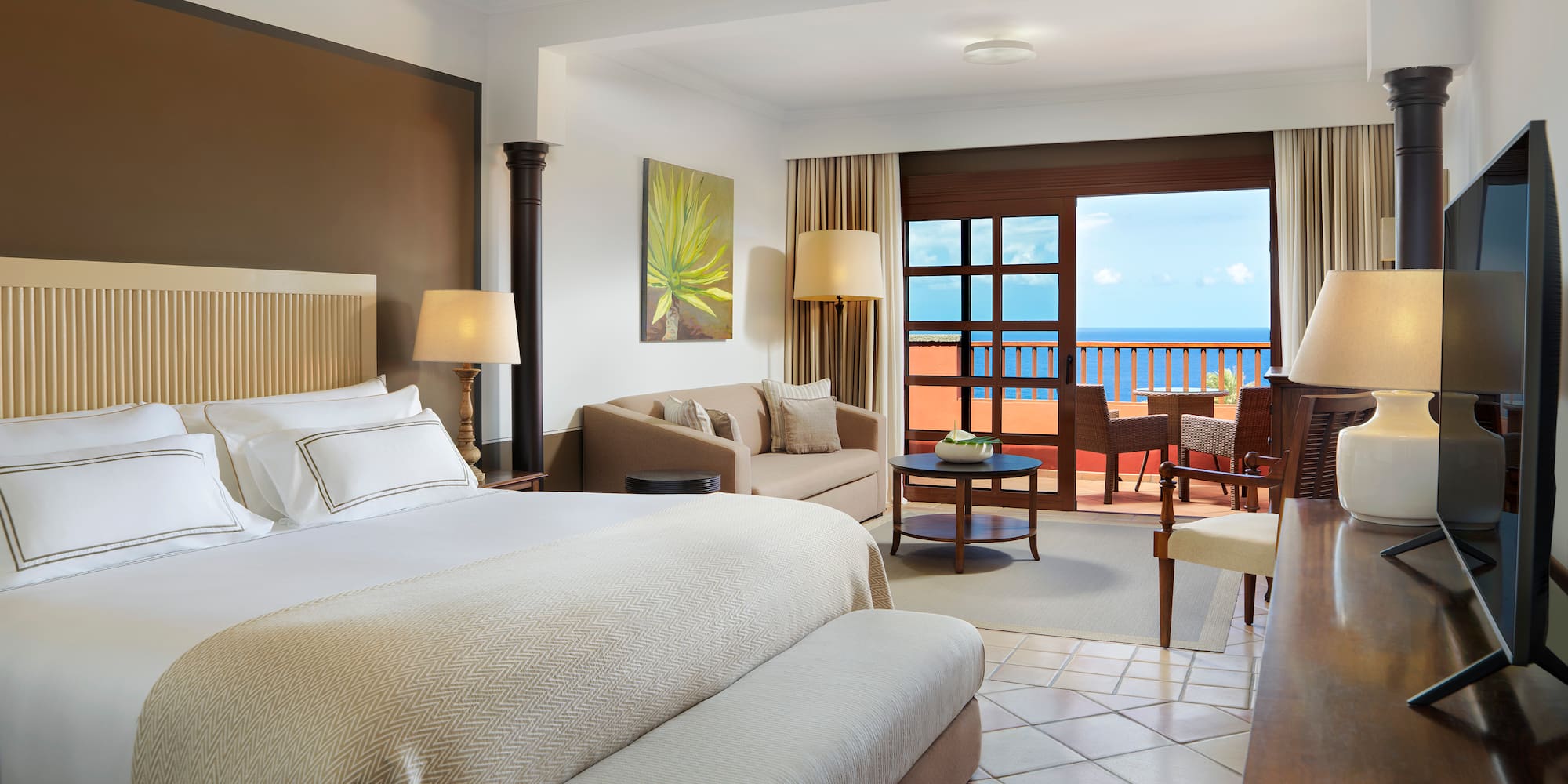 a room with a bed and a table and chairs