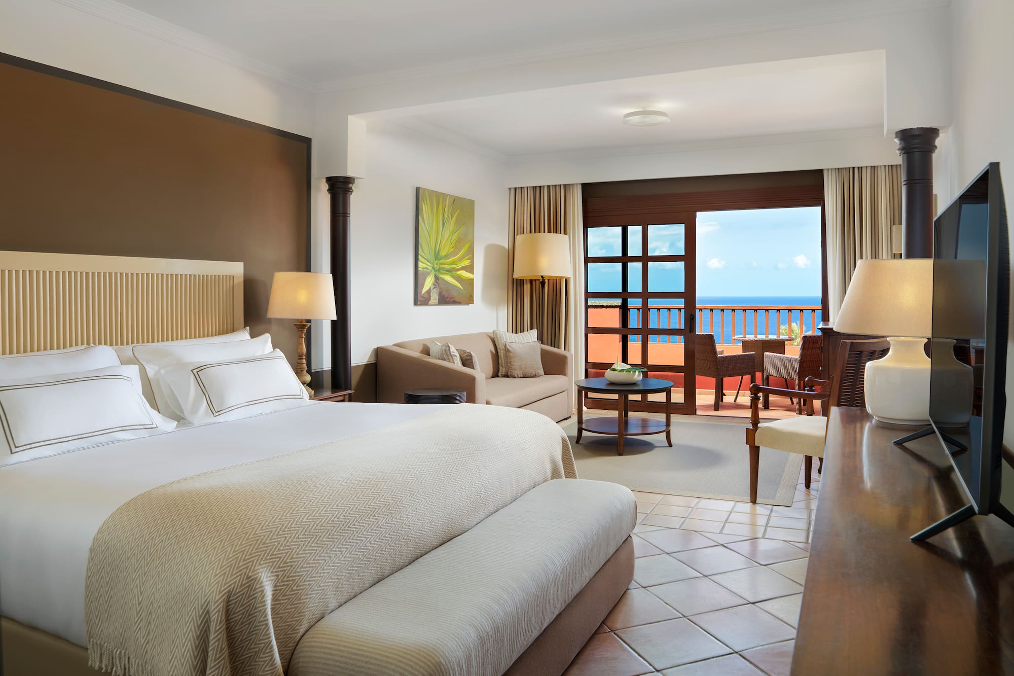 a room with a bed and a table and chairs