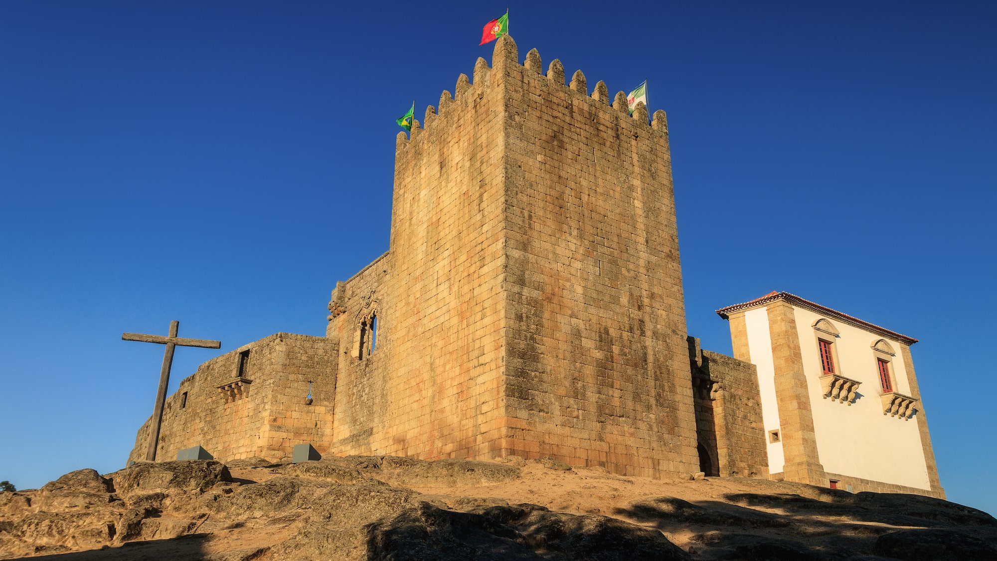 a stone castle with flags on top