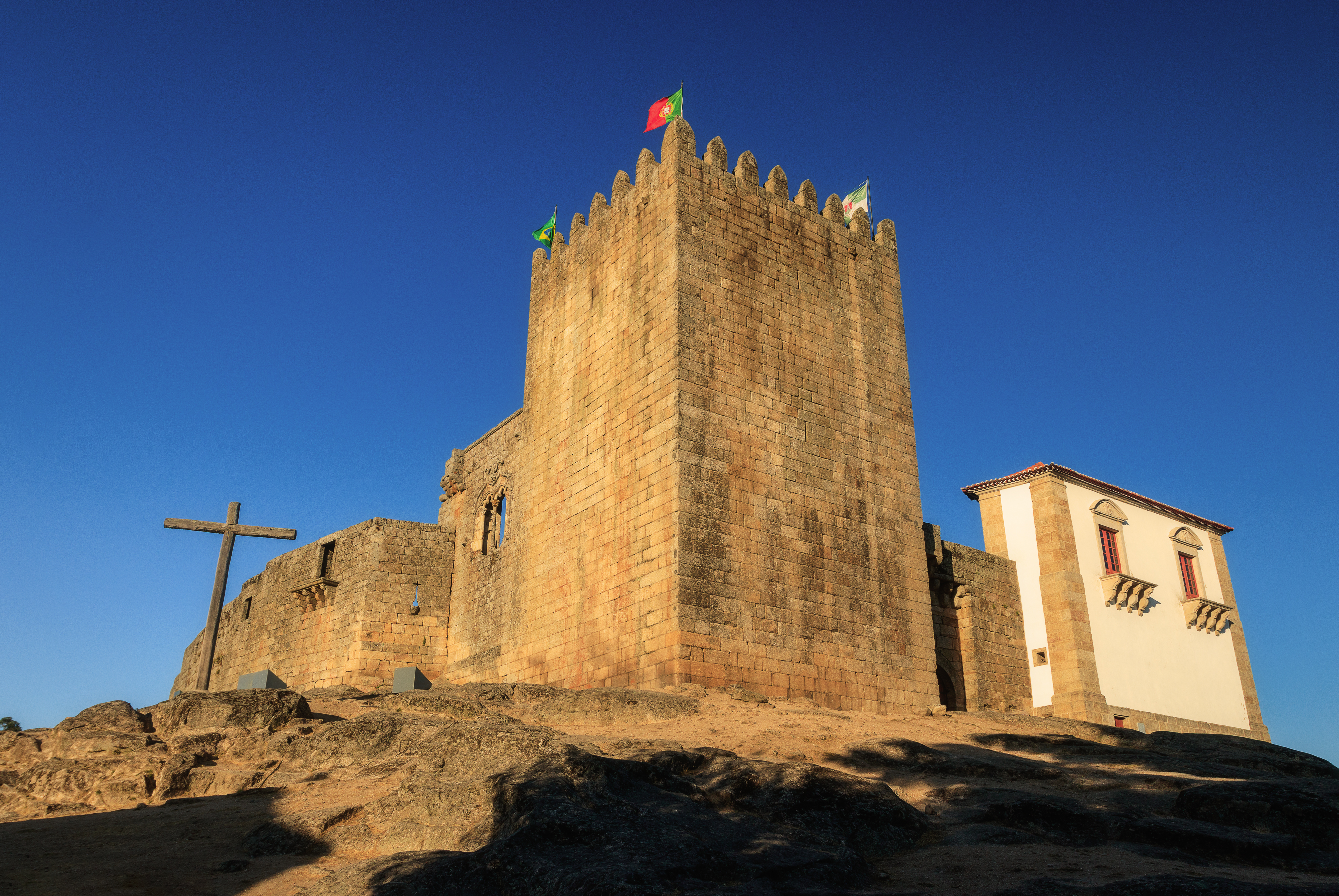 a stone castle with flags on top