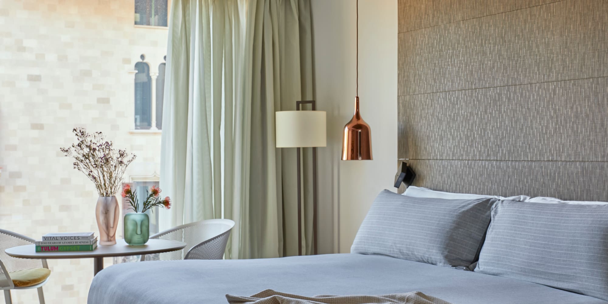 a bed with a lamp and a table in a room