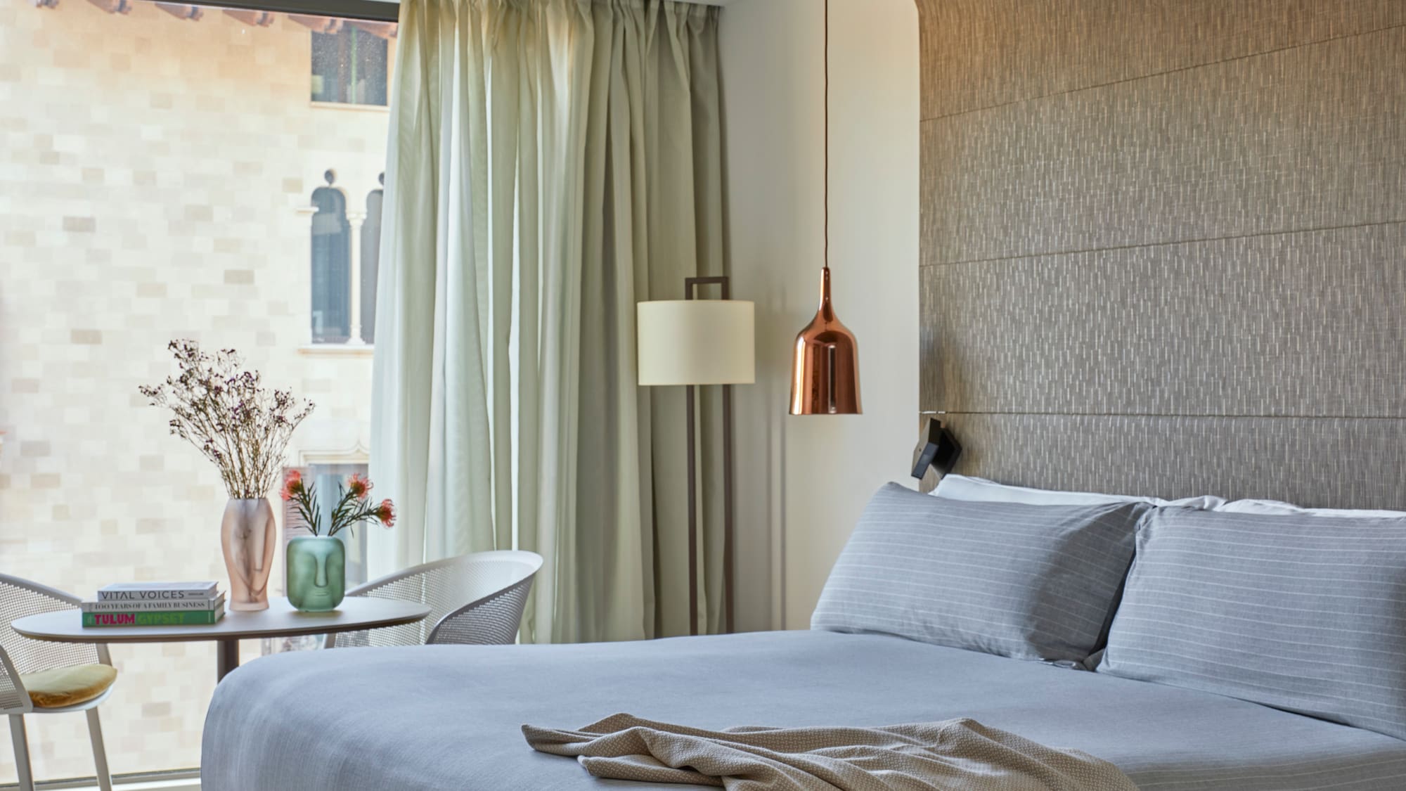 a bed with a lamp and a table in a room