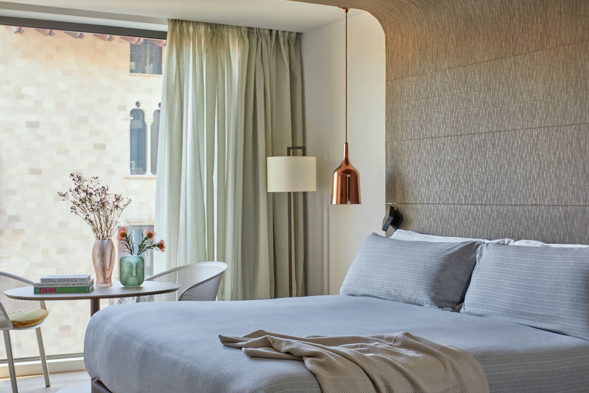 a bed with a lamp and a table in a room