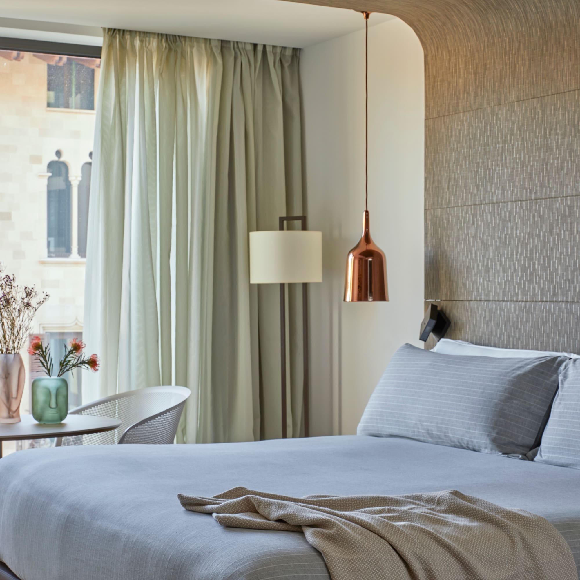 a bed with a lamp and a table in a room