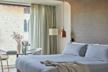 a bed with a lamp and a table in a room