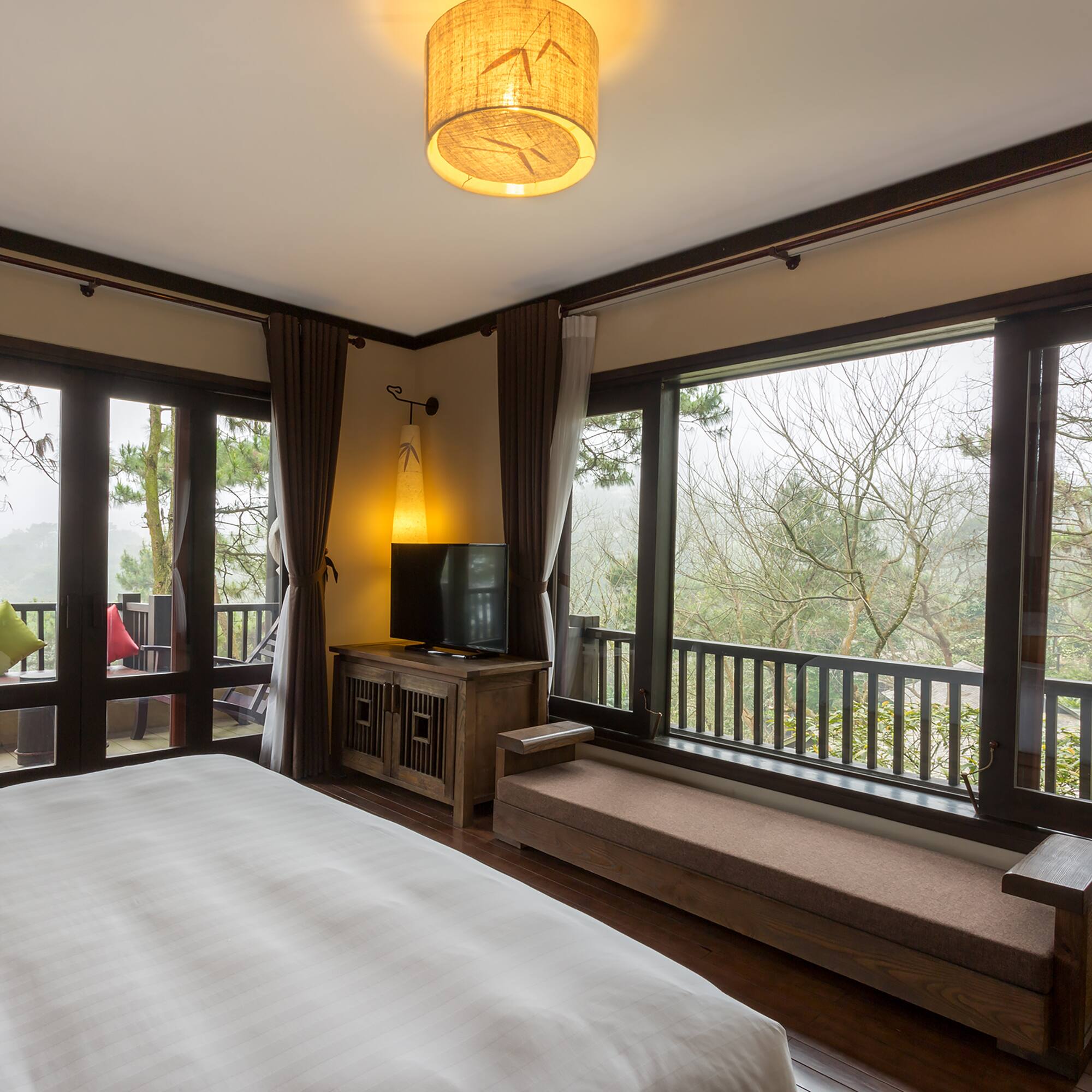 a bedroom with a bed and a bench and a window