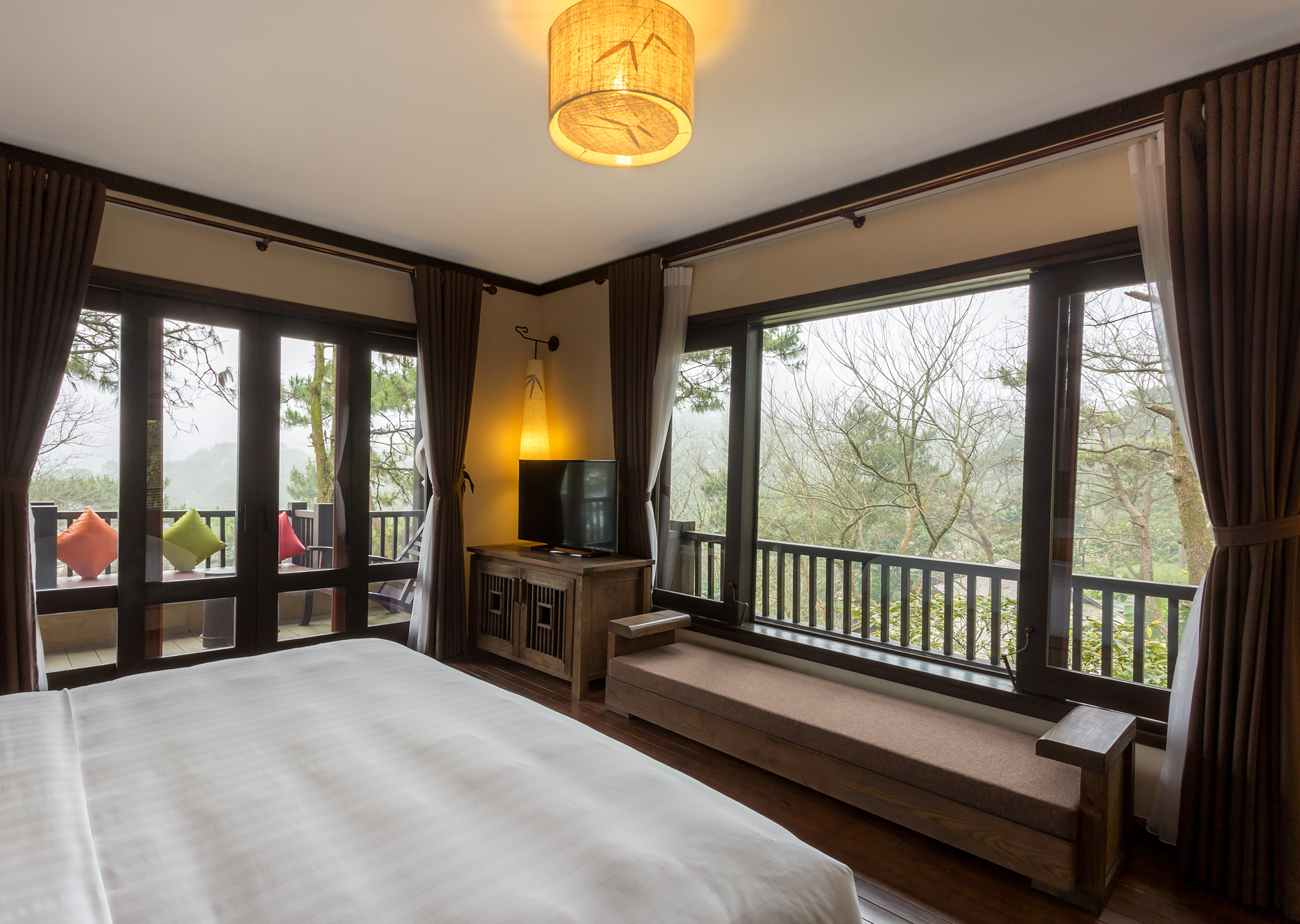 a bedroom with a bed and a bench and a window