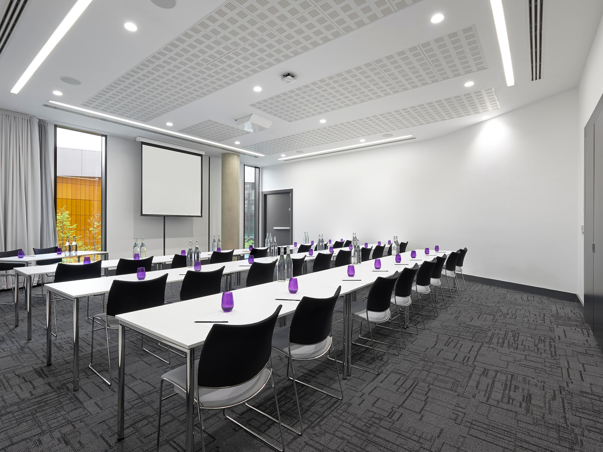 a room with white tables and chairs