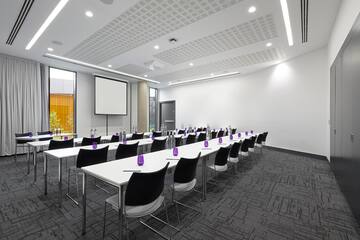 a room with white tables and chairs