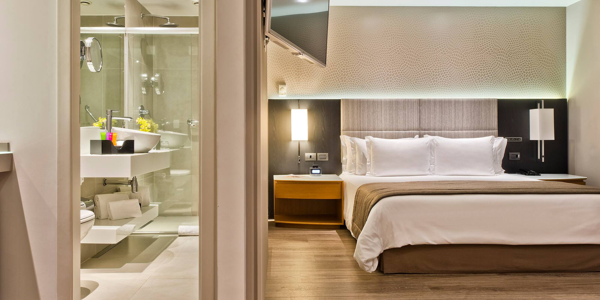 a bedroom with a glass shower door