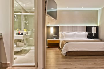 a bedroom with a glass shower door
