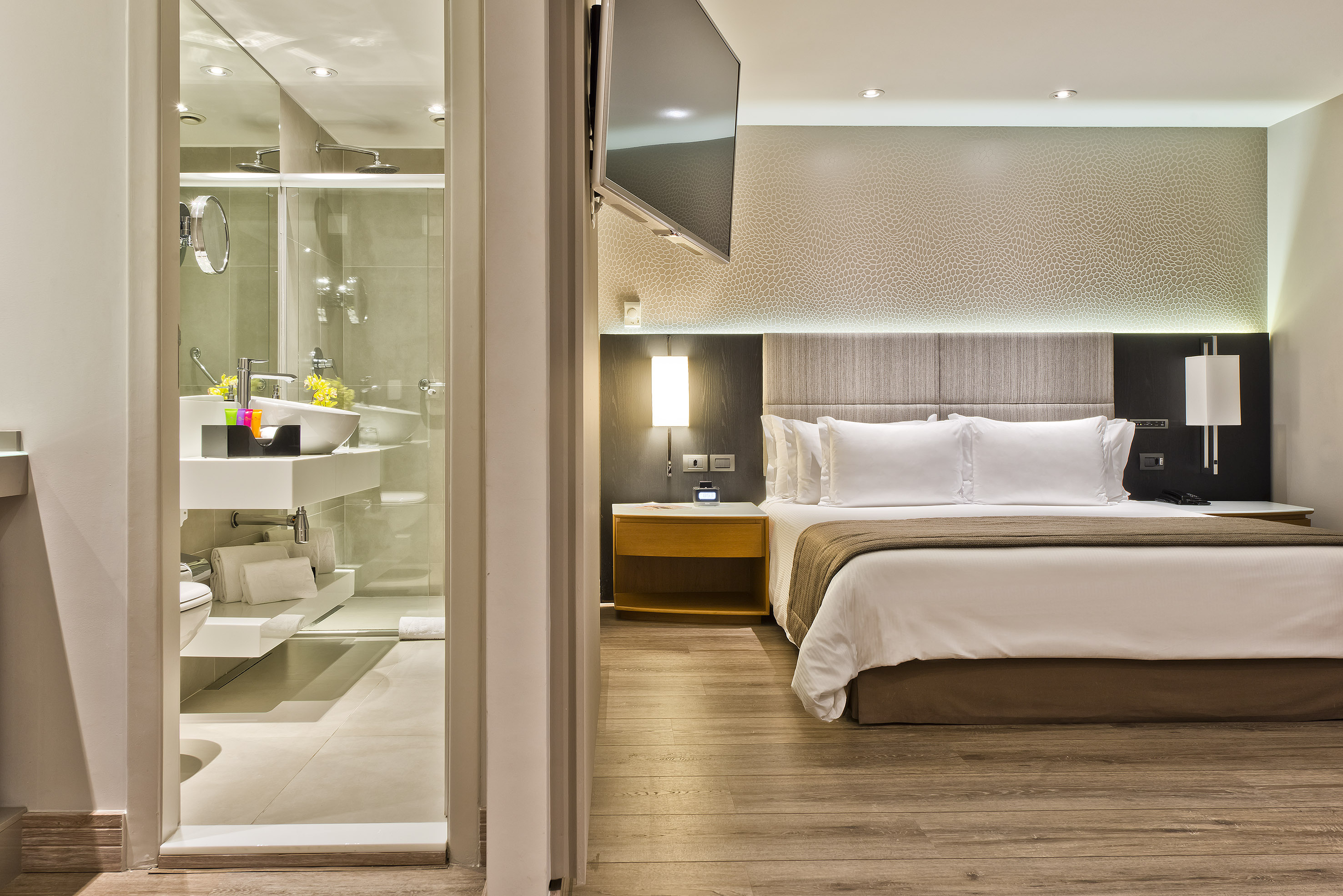 a bedroom with a glass shower door