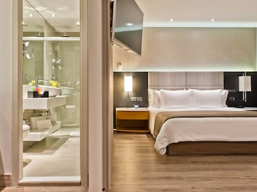 a bedroom with a glass shower door