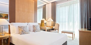 a bed with pillows and a desk in a room