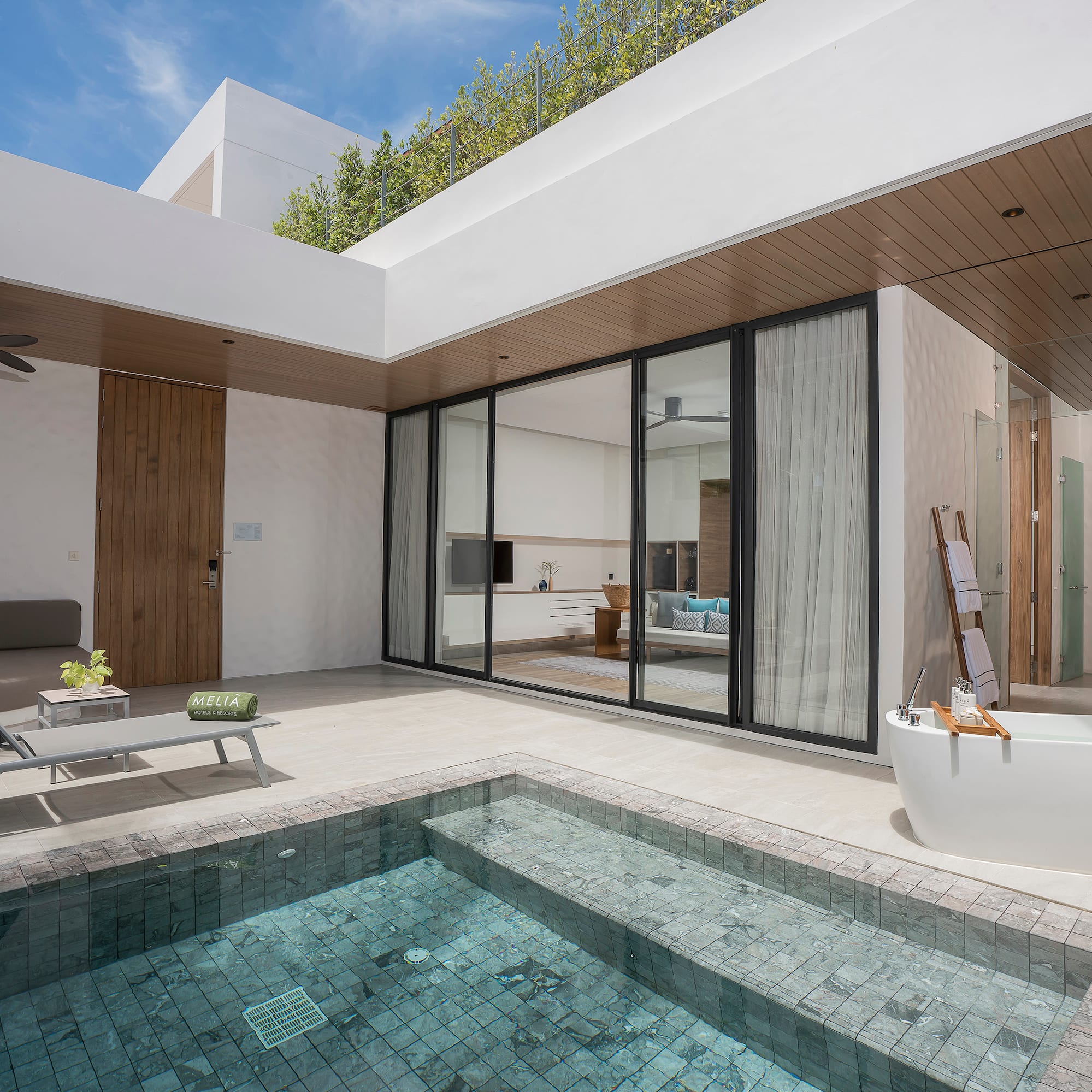 a swimming pool and a tub in a house