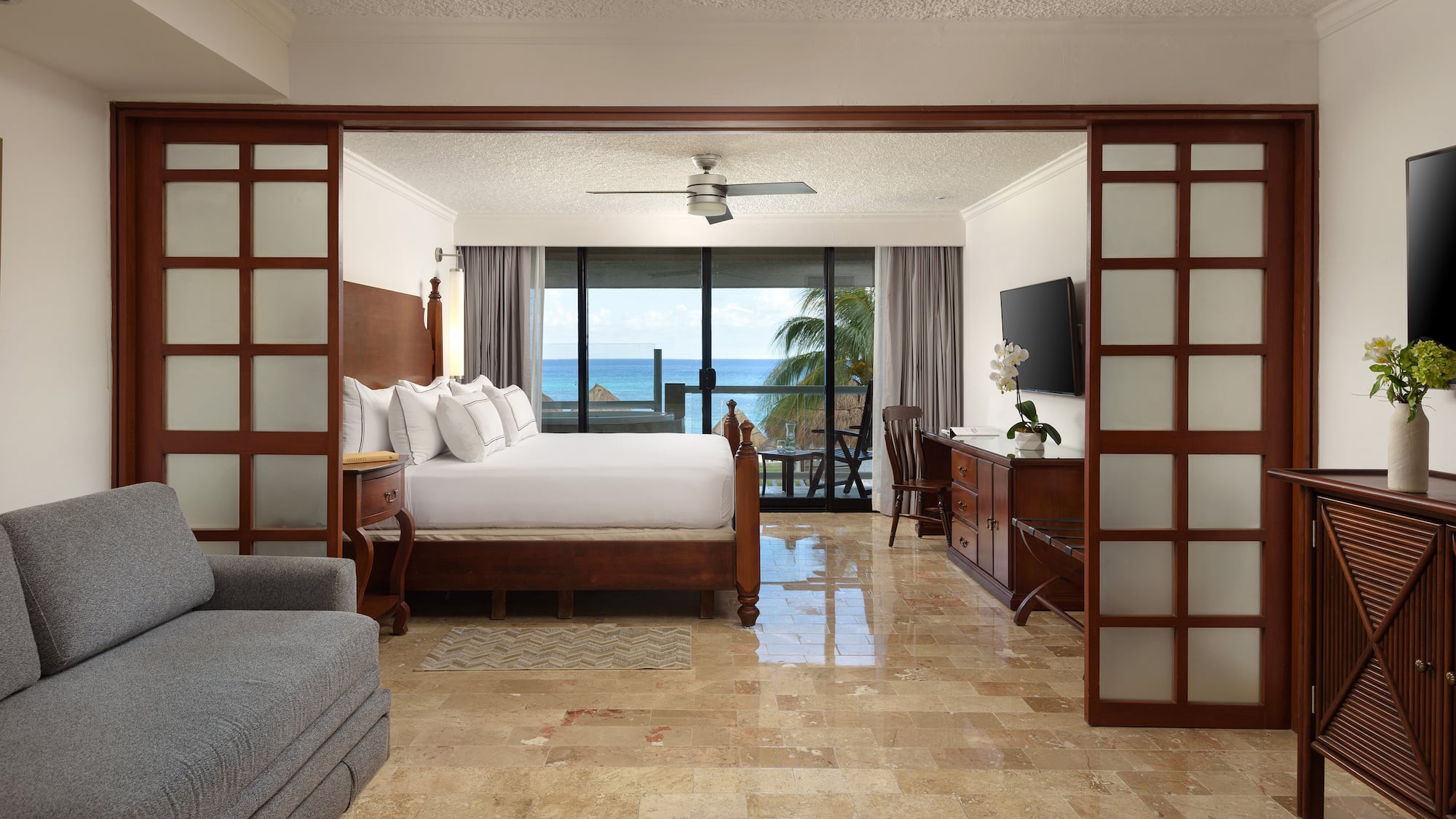 a room with a bed and a television