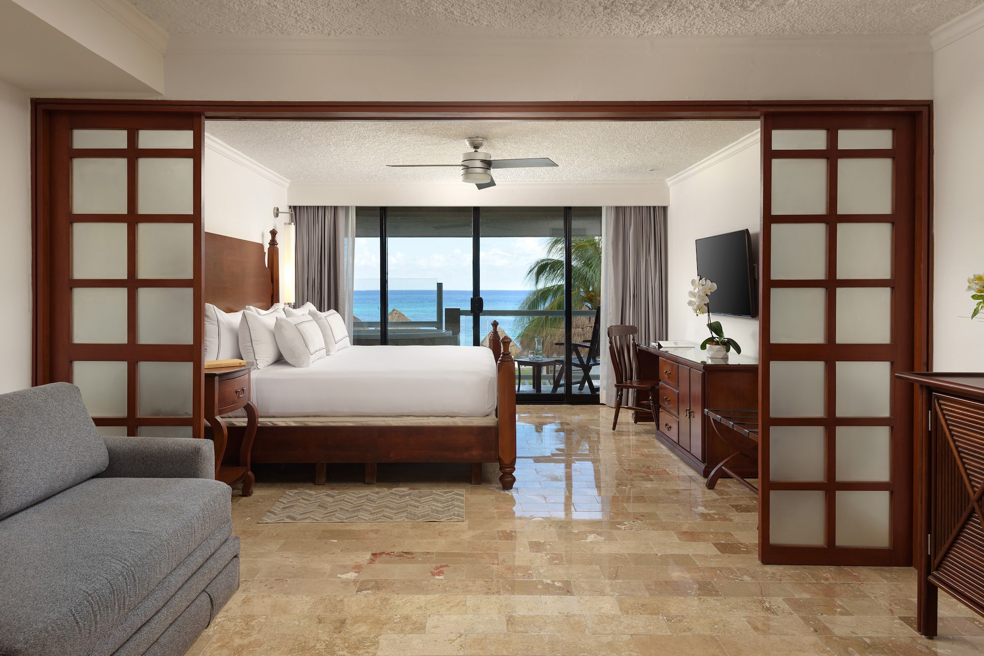 a room with a bed and a television