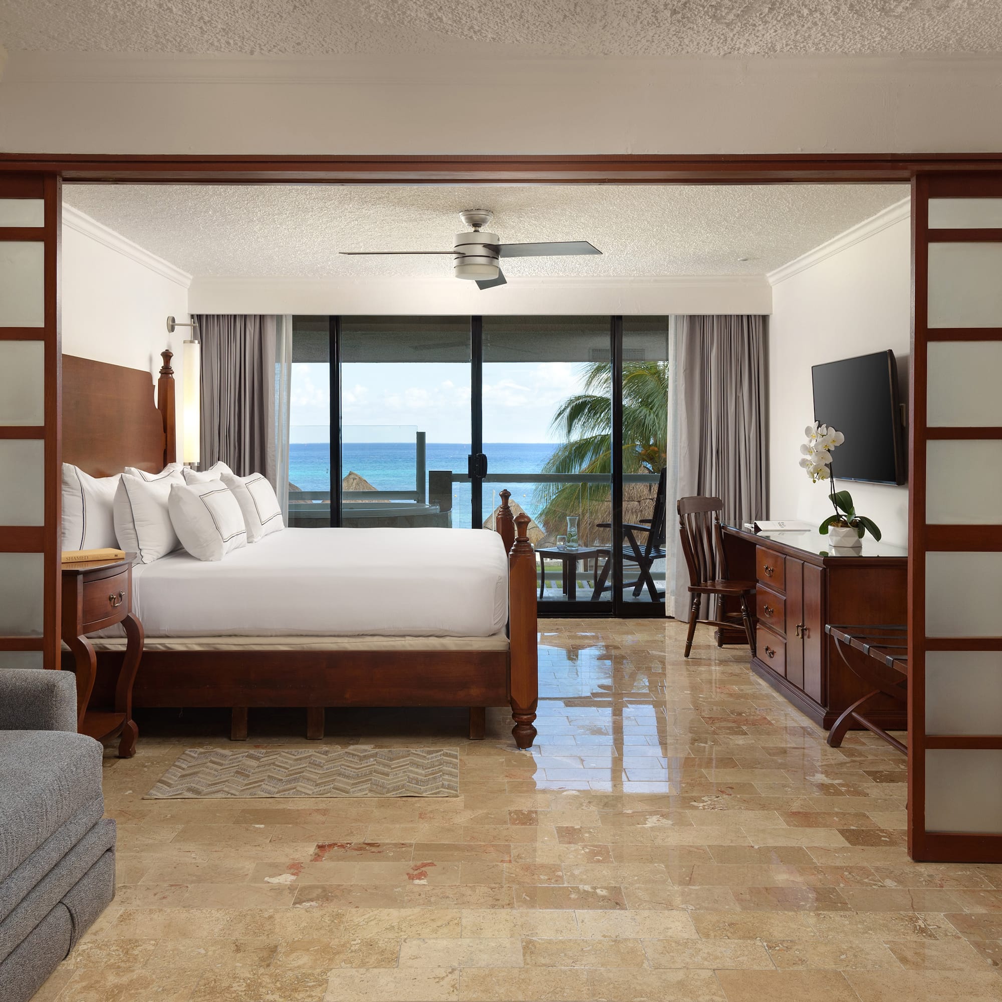 a room with a bed and a television